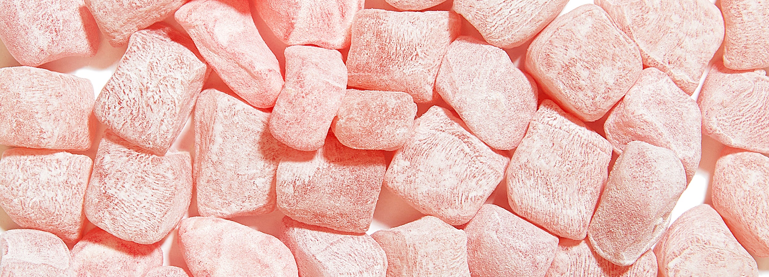 Close-up of pink Issei Mochi Gummies candies on a white background