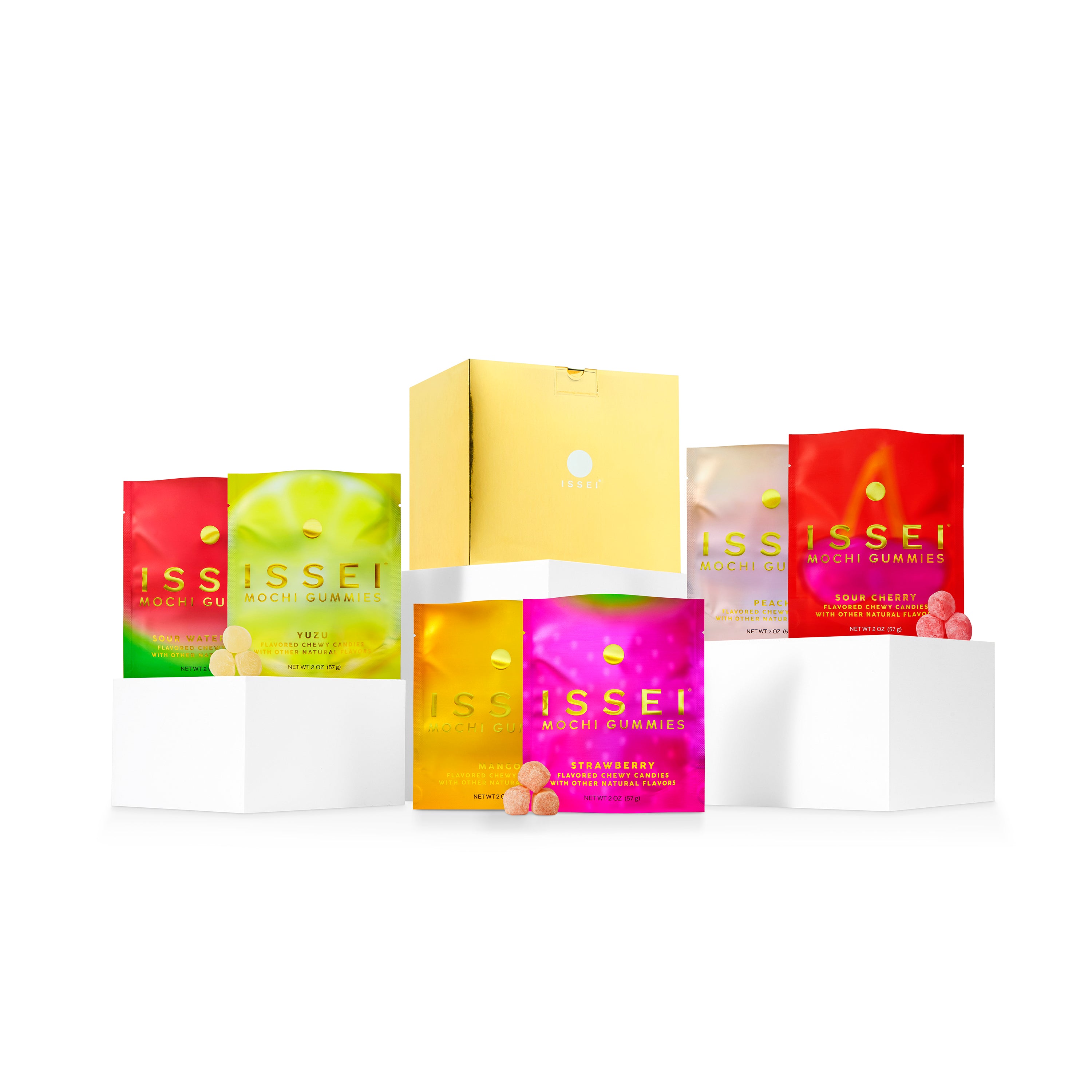 Assorted colorful packs of Issei mochi gummies shiny gold box on a white background