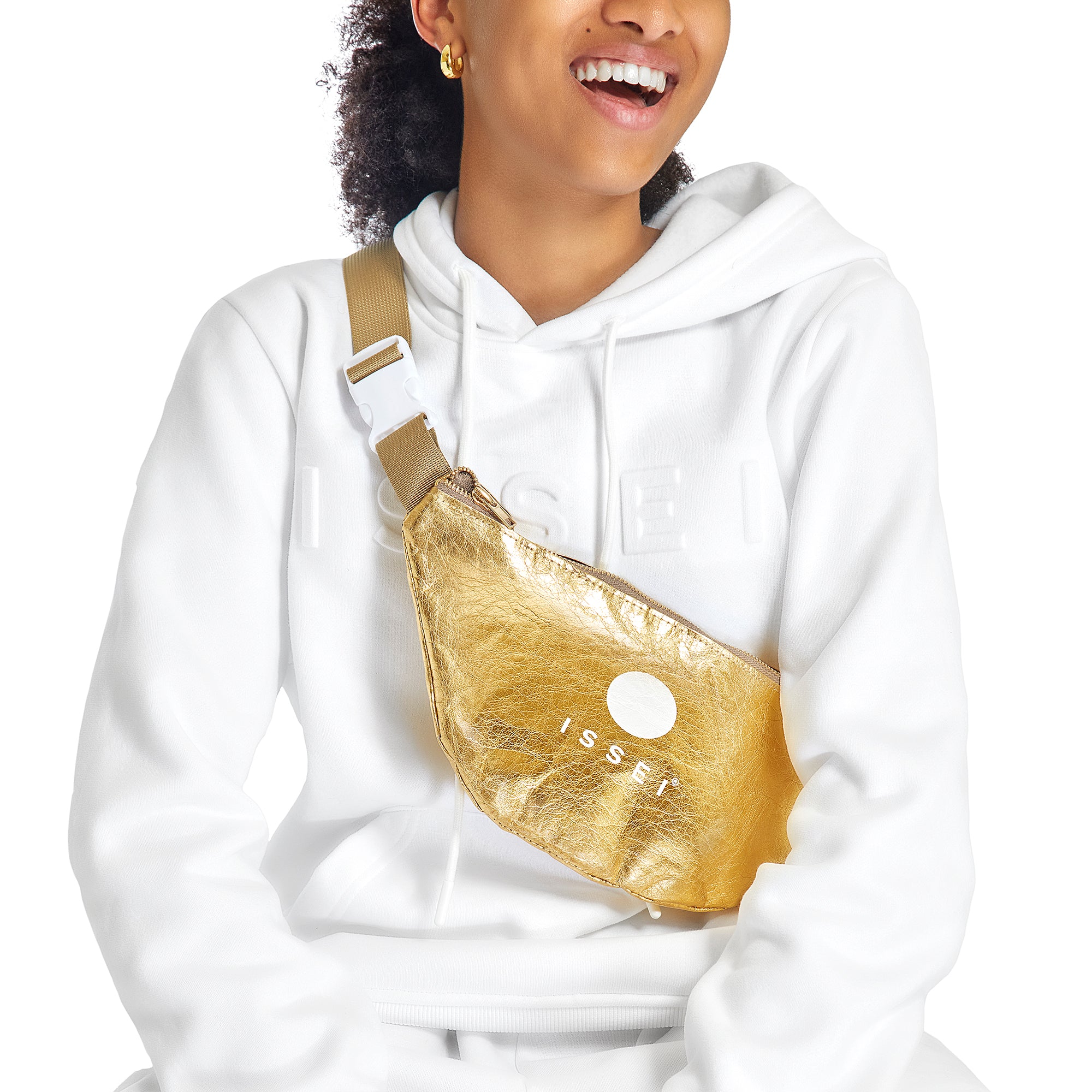 Person wearing a white Issei hoodie with a gold metallic fanny pack.