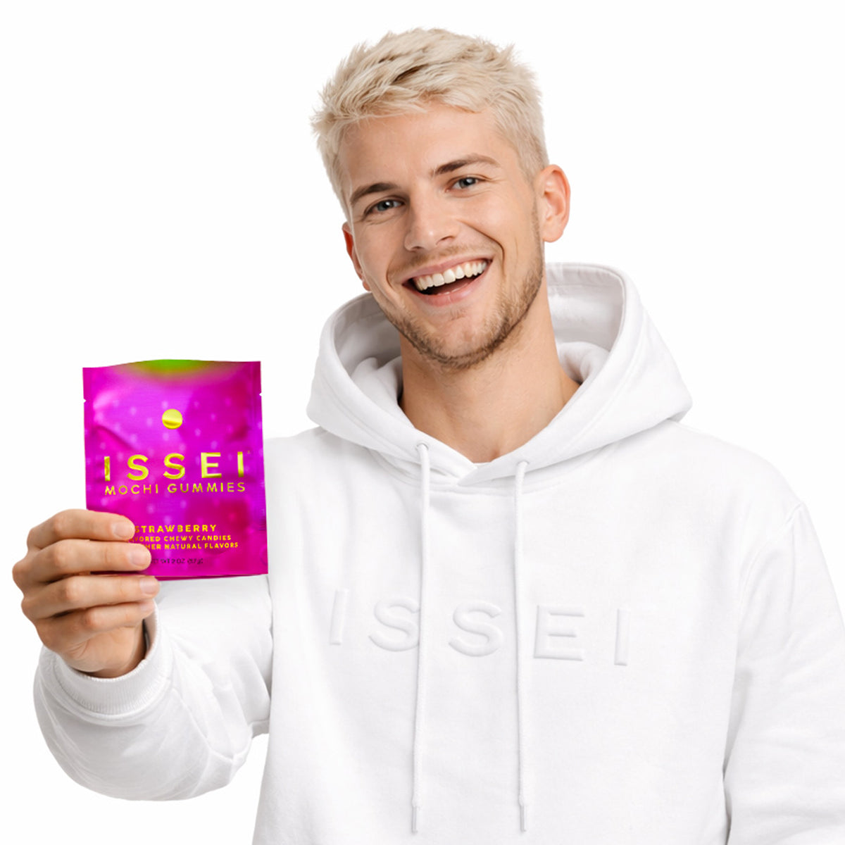 Man holding a pink packet of ISSEI Mochi Gummies against a white background
