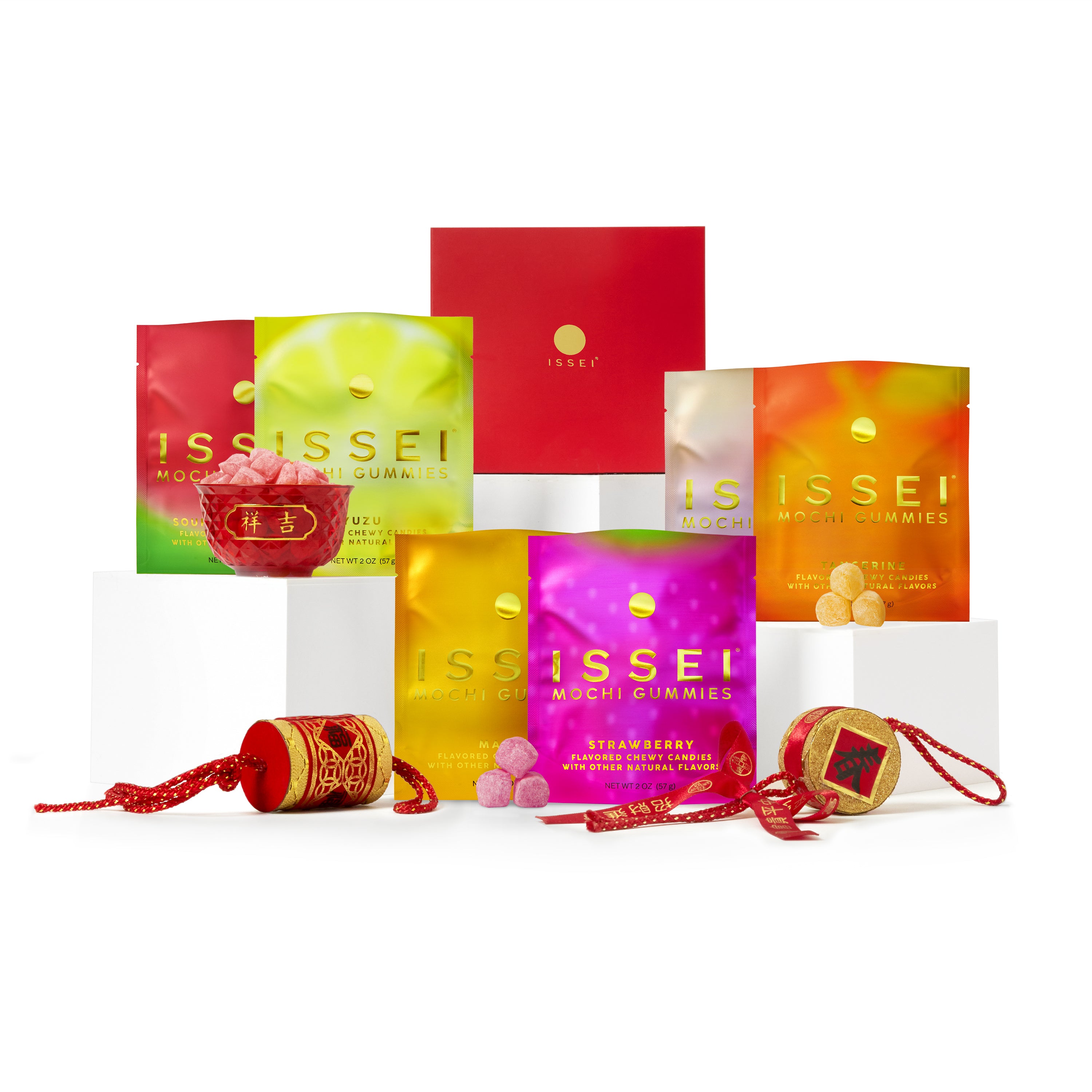 Assorted packages of Issei Mochi Gummies on a white background with festive Lunar New Year elements