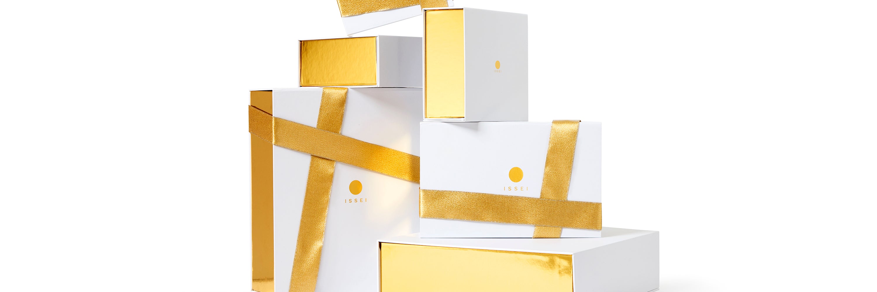 White and gold Issei gift boxes stacked on a white background